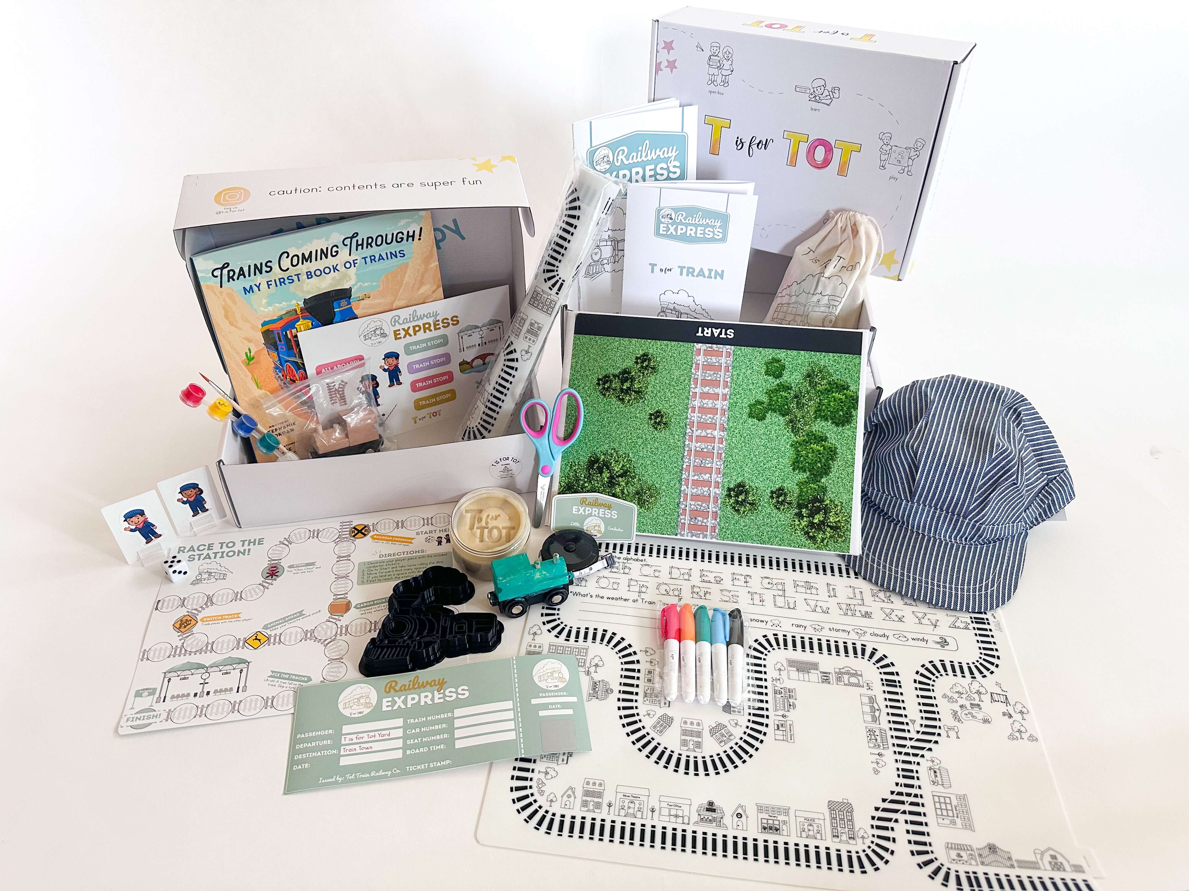 T is for Train Kit featuring educational materials, craft items, toy train, and a conductor